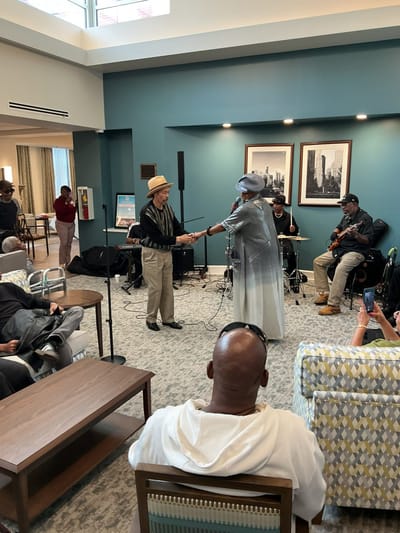 Residents enjoying live music performance in a common area