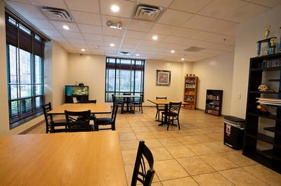 Common area with tables and seating in a bright room