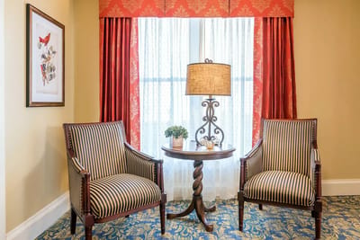 Cozy seating area with two chairs and a lamp