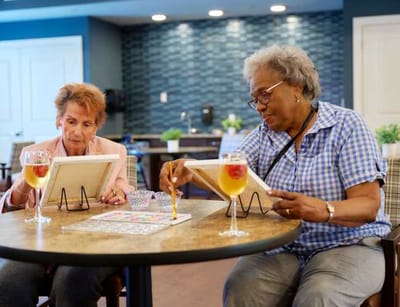 Residents engaged in an art activity in a common area