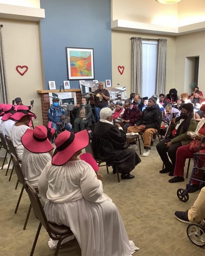Residents and staff celebrating an event in an activity room