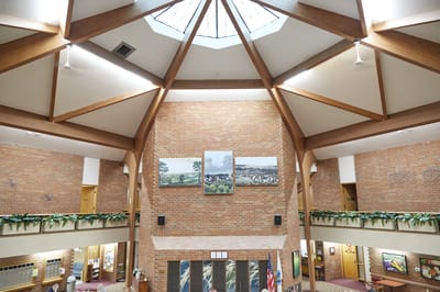 Interior view of a lobby with high ceilings and artwork