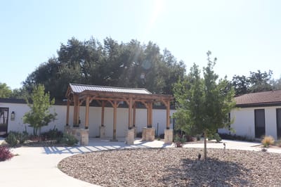 Outdoor seating area with shade structure and landscaping