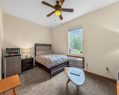 Bright resident room with a bed and window