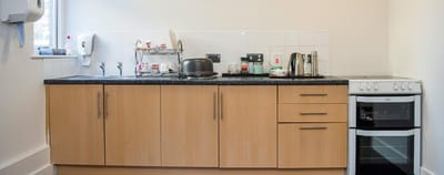 Modern kitchen area with appliances and storage