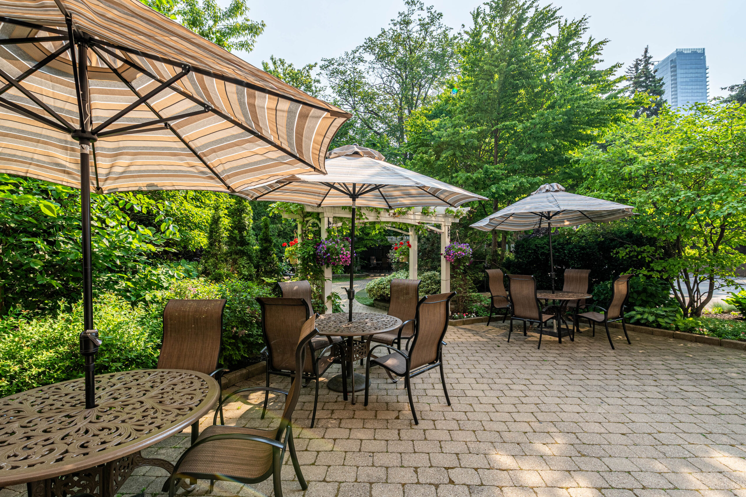 Outdoor seating area with tables and umbrellas in a garden