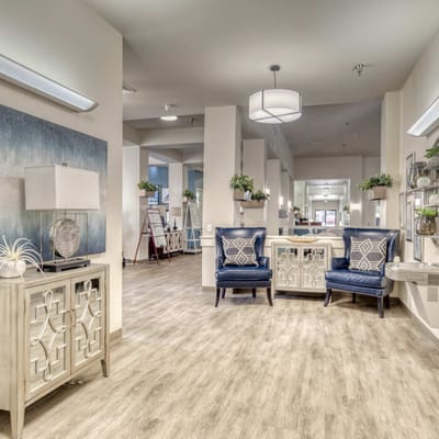 Bright common area with blue chairs and decorative lamps