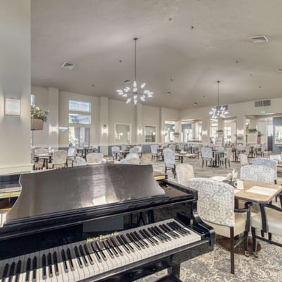 Interior dining area with piano and seating