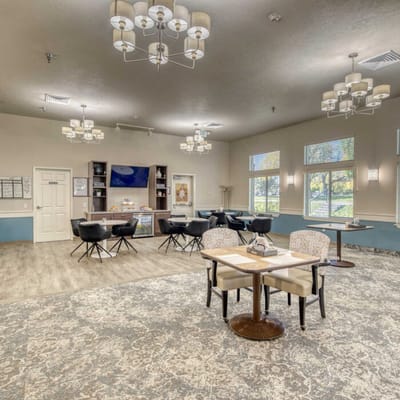 Bright common area with comfortable seating and chandeliers