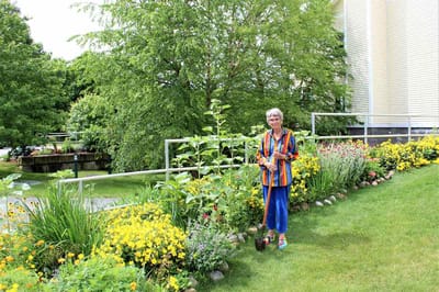Resident gardening in a colorful outdoor area