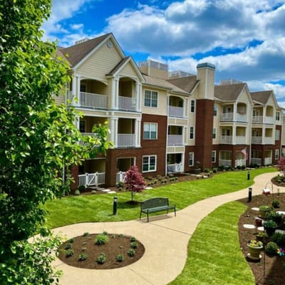 Exterior view of a senior living facility with landscaped gardens