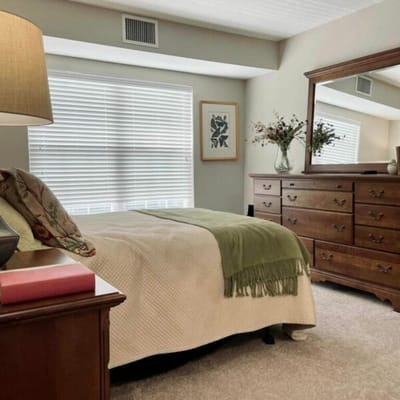 Cozy bedroom with a neatly made bed and natural light