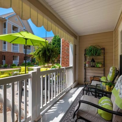 A cozy outdoor seating area with vibrant green accents