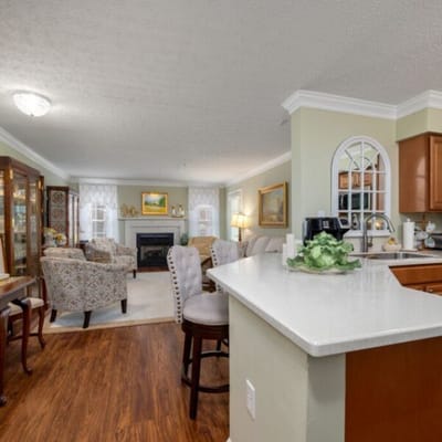 Bright common area with seating and fireplace