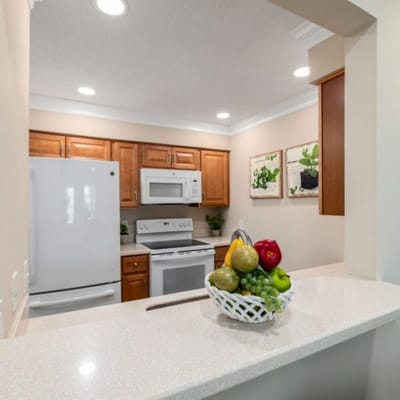 A modern kitchen with fresh fruits on the counter