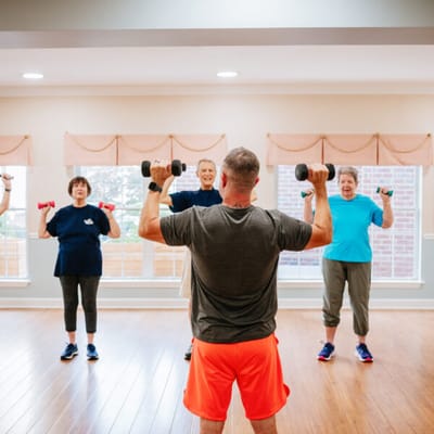 Residents participating in a seated exercise class