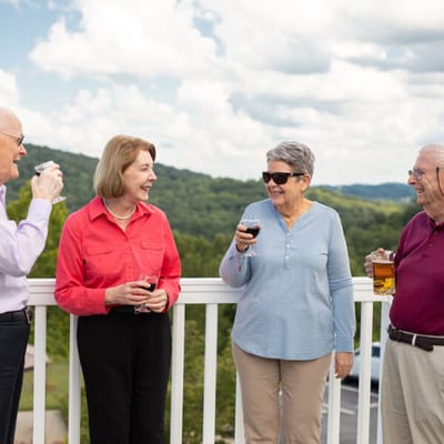 Residents enjoying drinks on an outdoor terrace