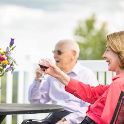 Residents enjoying drinks on an outdoor patio