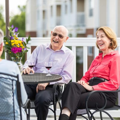 Residents enjoying drinks on an outdoor patio