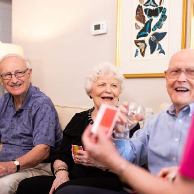 Residents enjoying a card game in a cozy setting