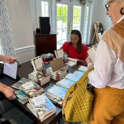 Residents and staff participating in a book signing event
