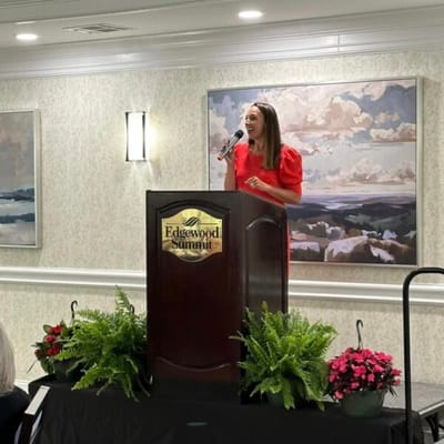 A woman speaking at a podium during an event