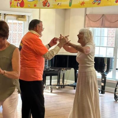 Residents dancing joyfully in a common area