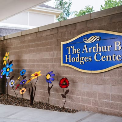 Sign for The Arthur B. Hodges Center with colorful flowers