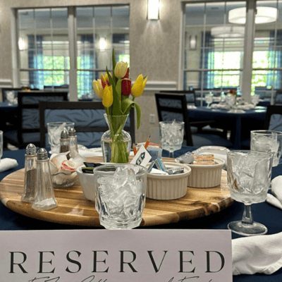 Dining table set for a meal with flowers and drinks