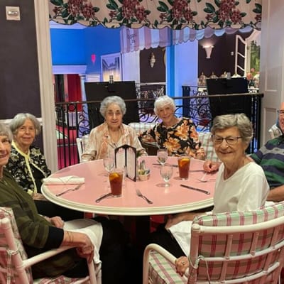 Residents enjoying drinks at a dining table