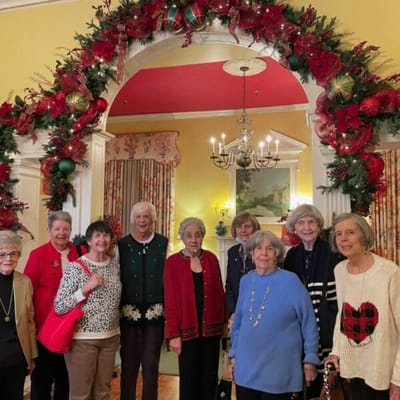 Residents posing together in a festive common area