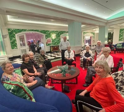 Residents enjoying a social gathering in a colorful lounge