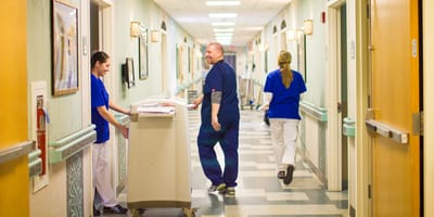 Staff interacting in a bright hallway of the facility