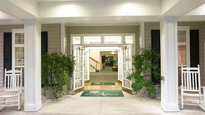 Entrance to Atria Forest Lake with rocking chairs and plants