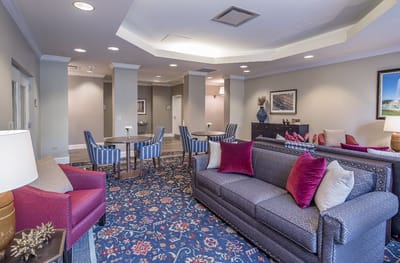 Bright common area with cozy seating in a senior living facility