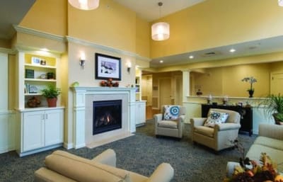 Bright common area with seating and a fireplace