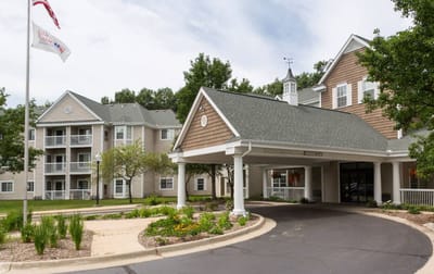 Exterior view of Baldwin House Senior Living entrance with garden
