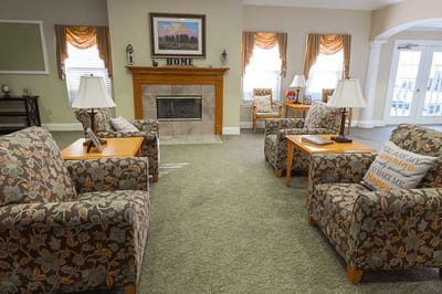 Cozy lounge area with floral furniture and fireplace