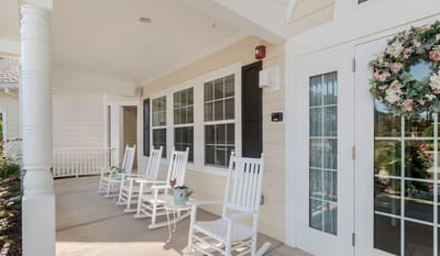 Rocking chairs on a porch with flower decorations