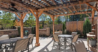 Outdoor patio area with seating and greenery