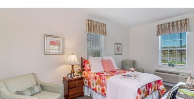 Bright and welcoming resident room with floral bedding