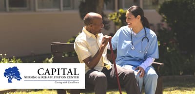 A nurse helping a resident outdoors