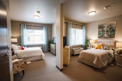 Two cozy resident rooms with natural light