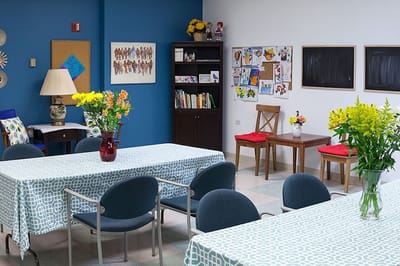Bright common area with tables and flowers