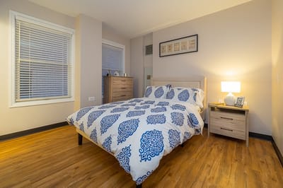 Cozy resident room with a bed and dresser