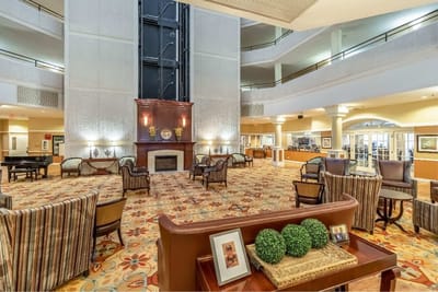 Bright common area with seating and a fireplace