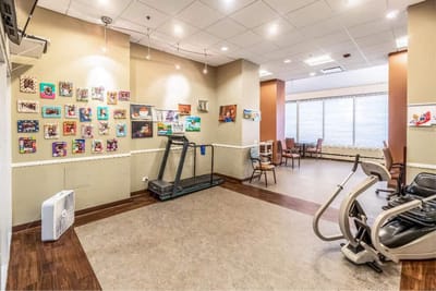 Interior view of a gym area with equipment and artwork