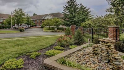 Exterior view of assisted living facility with landscaped gardens