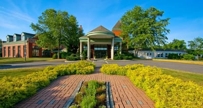 Exterior view of Evergreen Woods facility entrance and gardens