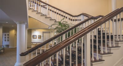 Interior view of a well-lit staircase in a nursing home